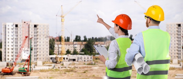 Image of Engineers in safety equipment at construction site, banner design