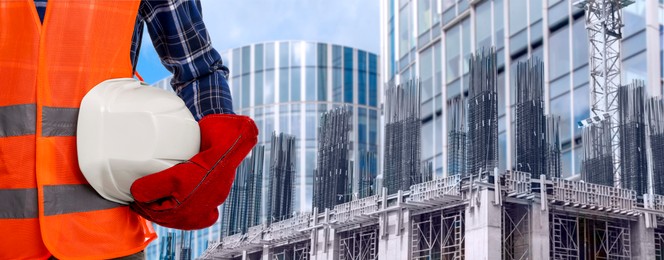 Image of Builder in safety equipment at construction site, closeup. Banner design