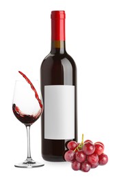 Image of Luxurious red wine in bottle with blank label, glass and grapes isolated on white