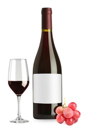 Image of Luxurious red wine in bottle with blank label, glass and grapes isolated on white