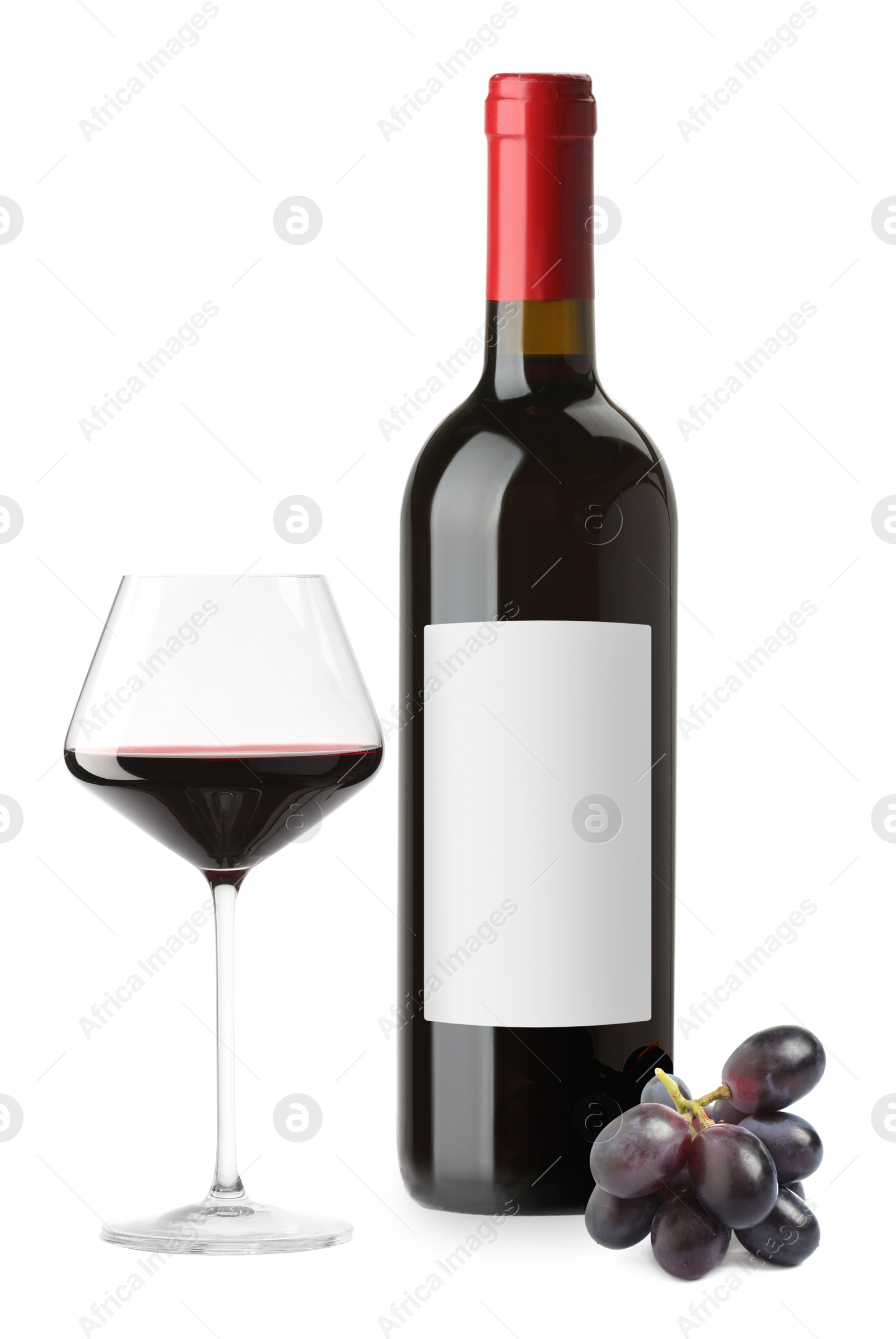 Luxurious red wine in bottle with blank label, glass and grapes isolated on white Image of Luxurious red wine in bottle with blank label, glass and grapes isolated on white