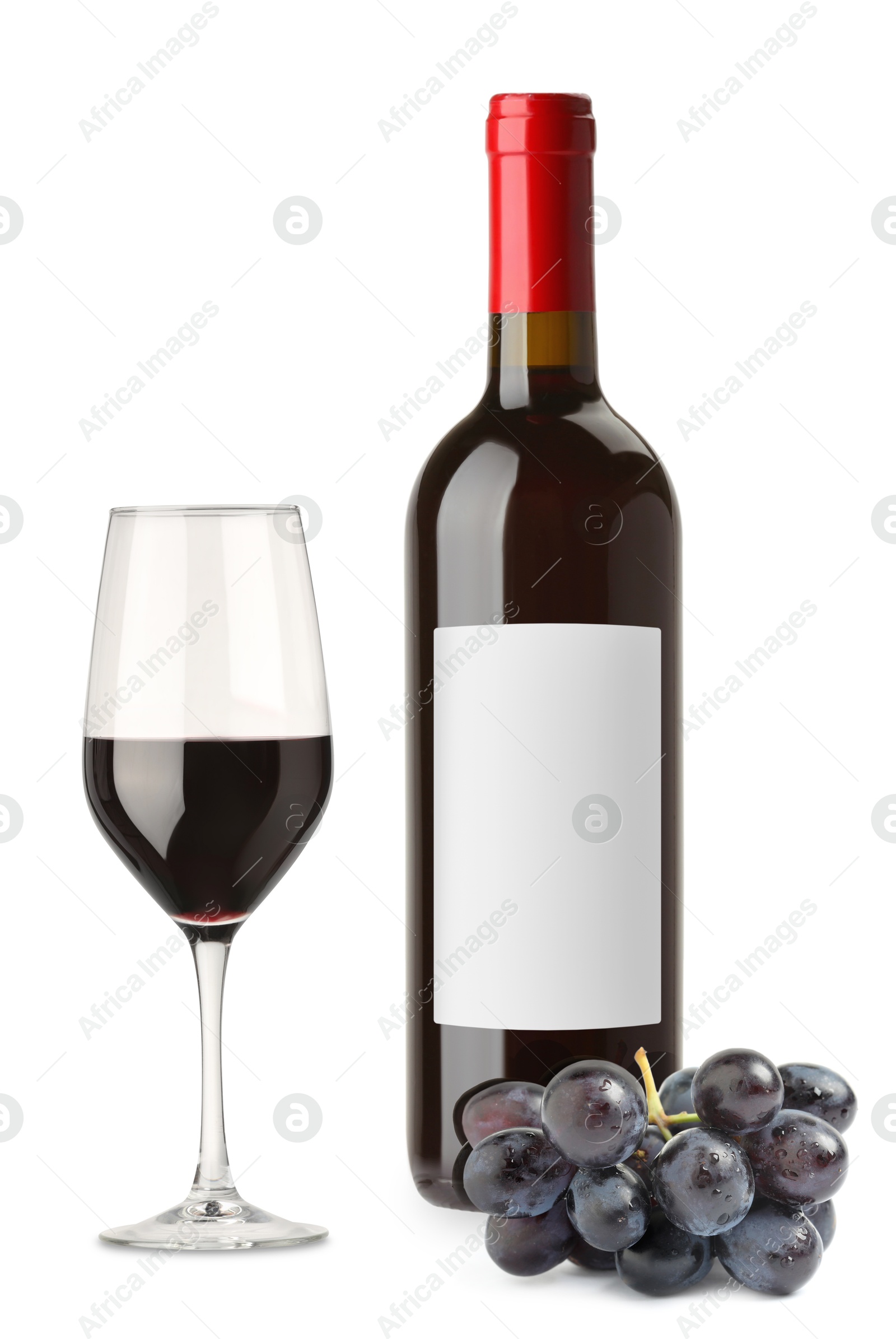 Luxurious red wine in bottle with blank label, glass and grapes isolated on white Image of Luxurious red wine in bottle with blank label, glass and grapes isolated on white