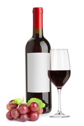 Image of Luxurious red wine in bottle with blank label, glass and grapes isolated on white