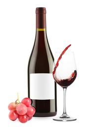Image of Luxurious red wine in bottle with blank label, glass and grapes isolated on white