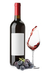 Image of Luxurious red wine in bottle with blank label, glass and grapes isolated on white