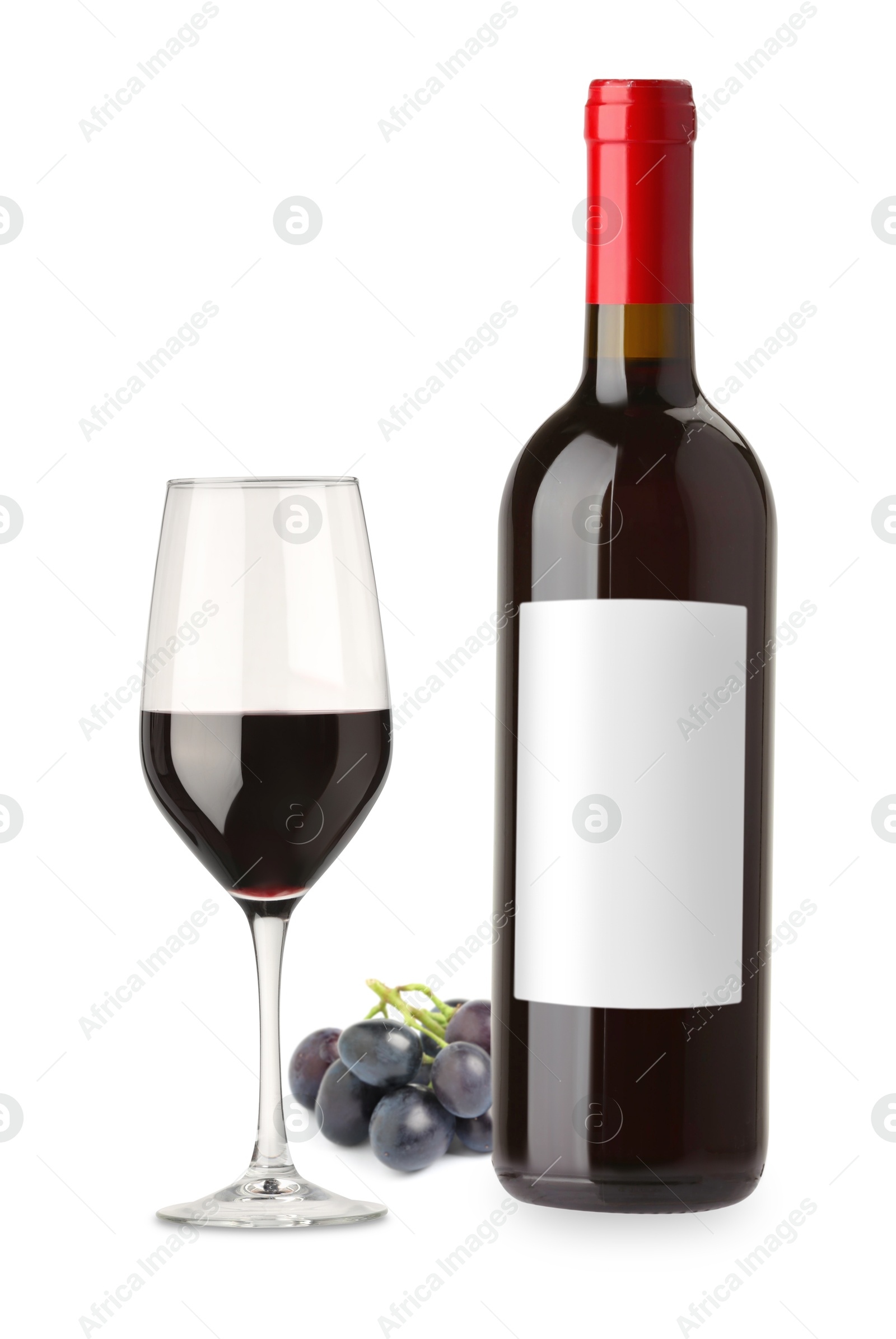 Luxurious red wine in bottle with blank label, glass and grapes isolated on white Image of Luxurious red wine in bottle with blank label, glass and grapes isolated on white