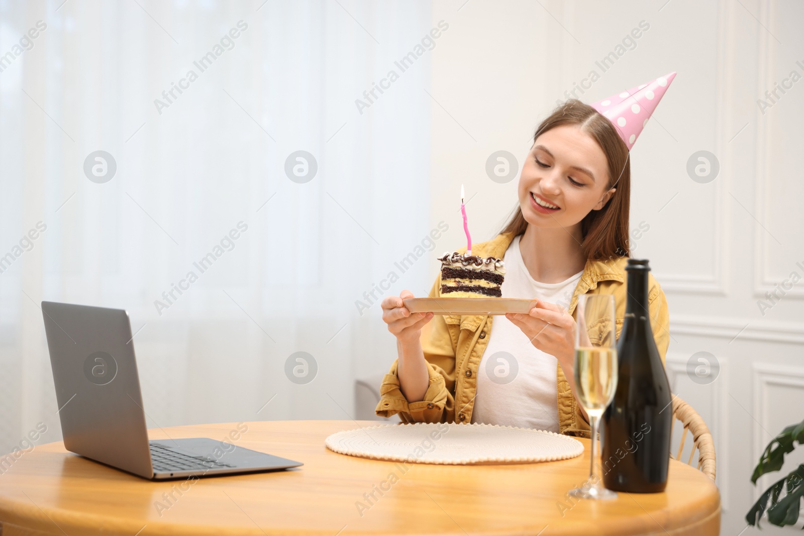 Birthday celebration. Happy woman with piece of cake having video call via laptop at home Photo of Birthday celebration. Happy woman with piece of cake having video call via laptop at home