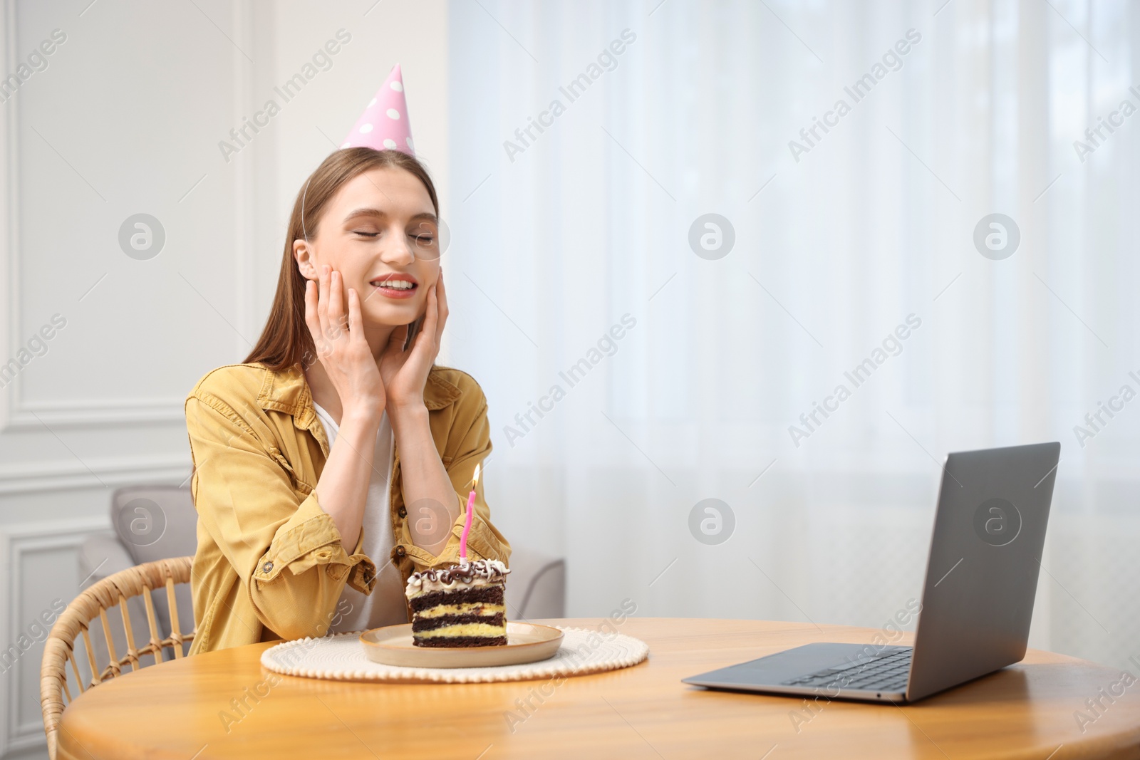 Birthday celebration. Happy woman with piece of cake having video call via laptop at home Photo of Birthday celebration. Happy woman with piece of cake having video call via laptop at home