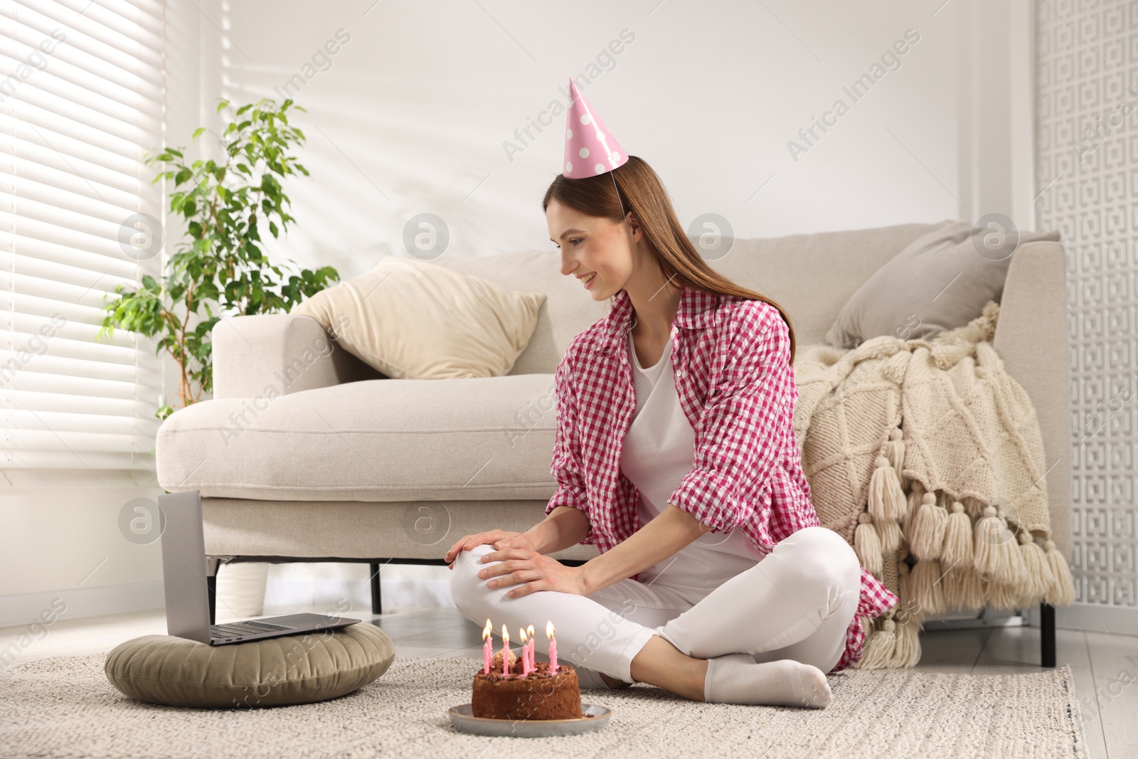 Birthday celebration. Happy woman with tasty cake having video call via laptop at home Photo of Birthday celebration. Happy woman with tasty cake having video call via laptop at home