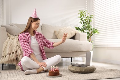 Photo of Birthday celebration. Happy woman with tasty cake having video call via laptop at home