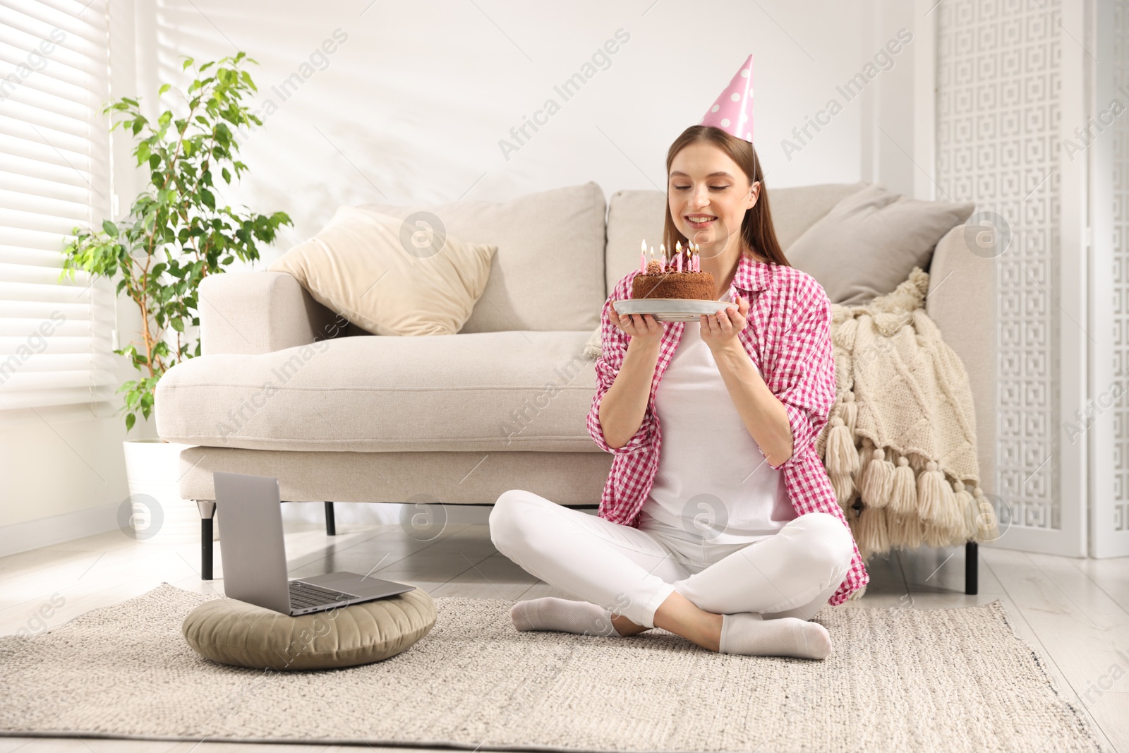 Birthday celebration. Happy woman with tasty cake having video call via laptop at home Photo of Birthday celebration. Happy woman with tasty cake having video call via laptop at home