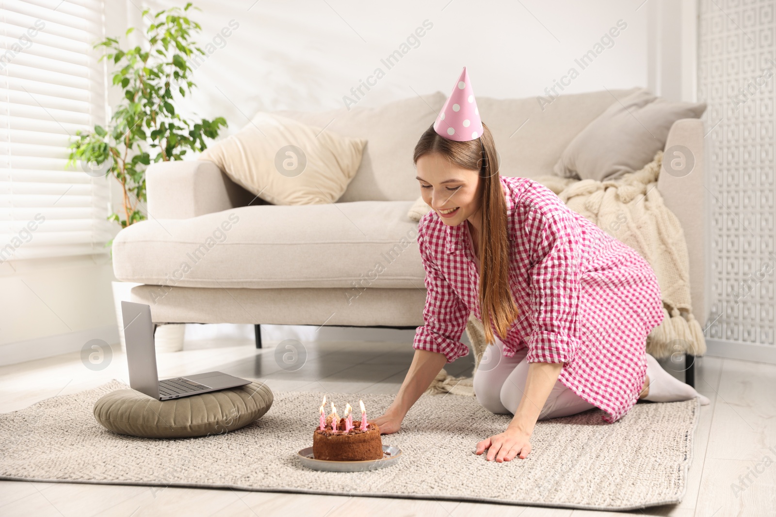 Birthday celebration. Happy woman with tasty cake having video call via laptop at home Photo of Birthday celebration. Happy woman with tasty cake having video call via laptop at home