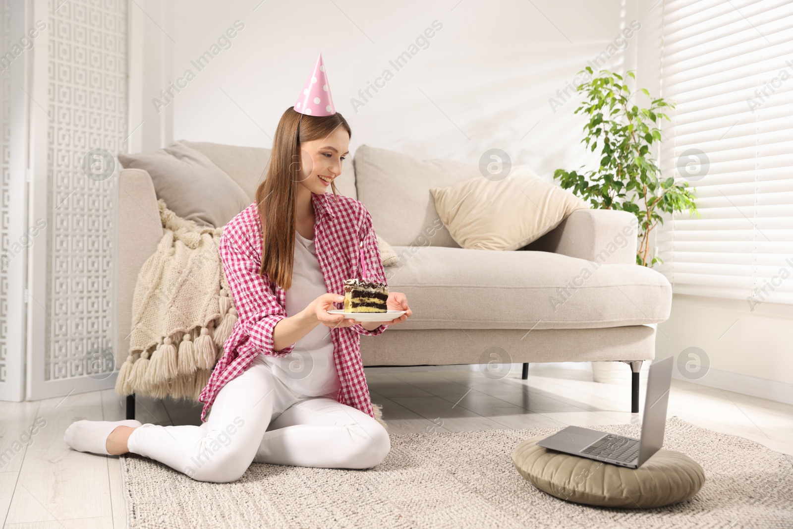 Birthday celebration. Happy woman with piece of cake having video call via laptop at home Photo of Birthday celebration. Happy woman with piece of cake having video call via laptop at home