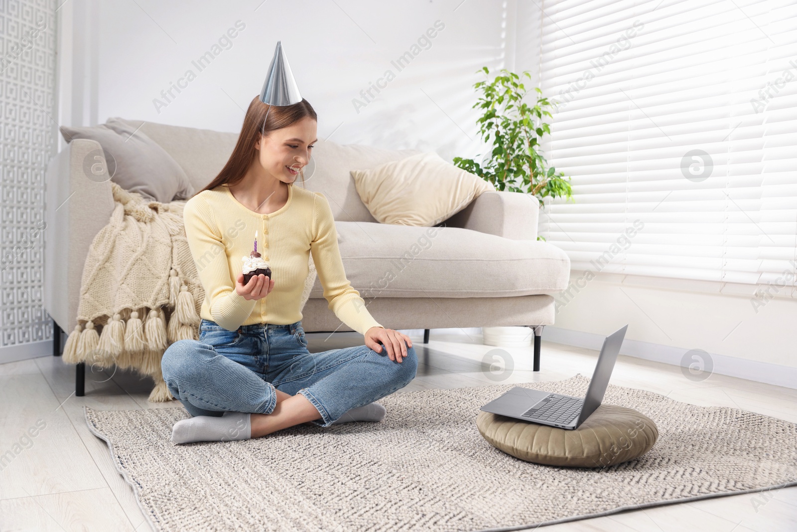 Birthday celebration. Happy woman with cupcake having video call via laptop at home Photo of Birthday celebration. Happy woman with cupcake having video call via laptop at home