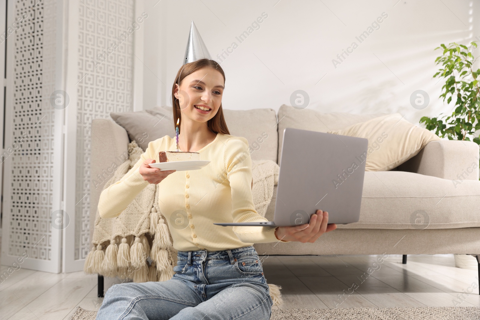 Birthday celebration. Happy woman with piece of cake having video call via laptop at home Photo of Birthday celebration. Happy woman with piece of cake having video call via laptop at home