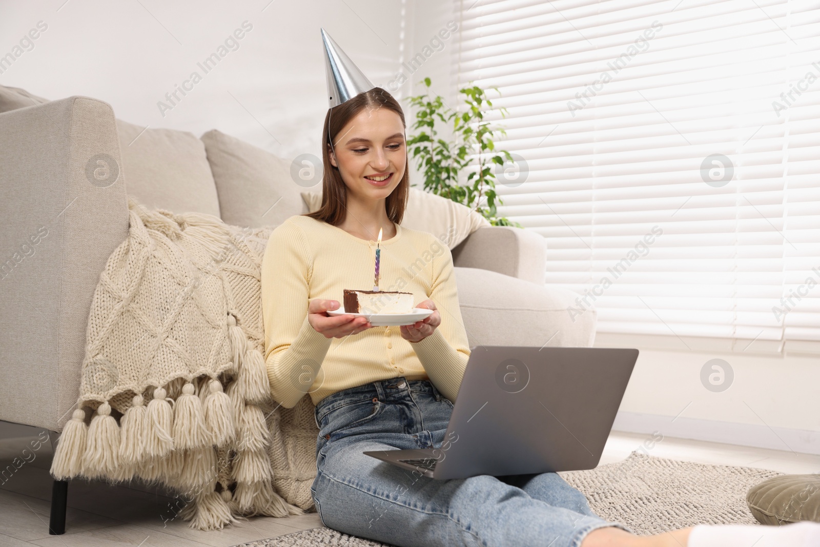 Birthday celebration. Happy woman with piece of cake having video call via laptop at home Photo of Birthday celebration. Happy woman with piece of cake having video call via laptop at home