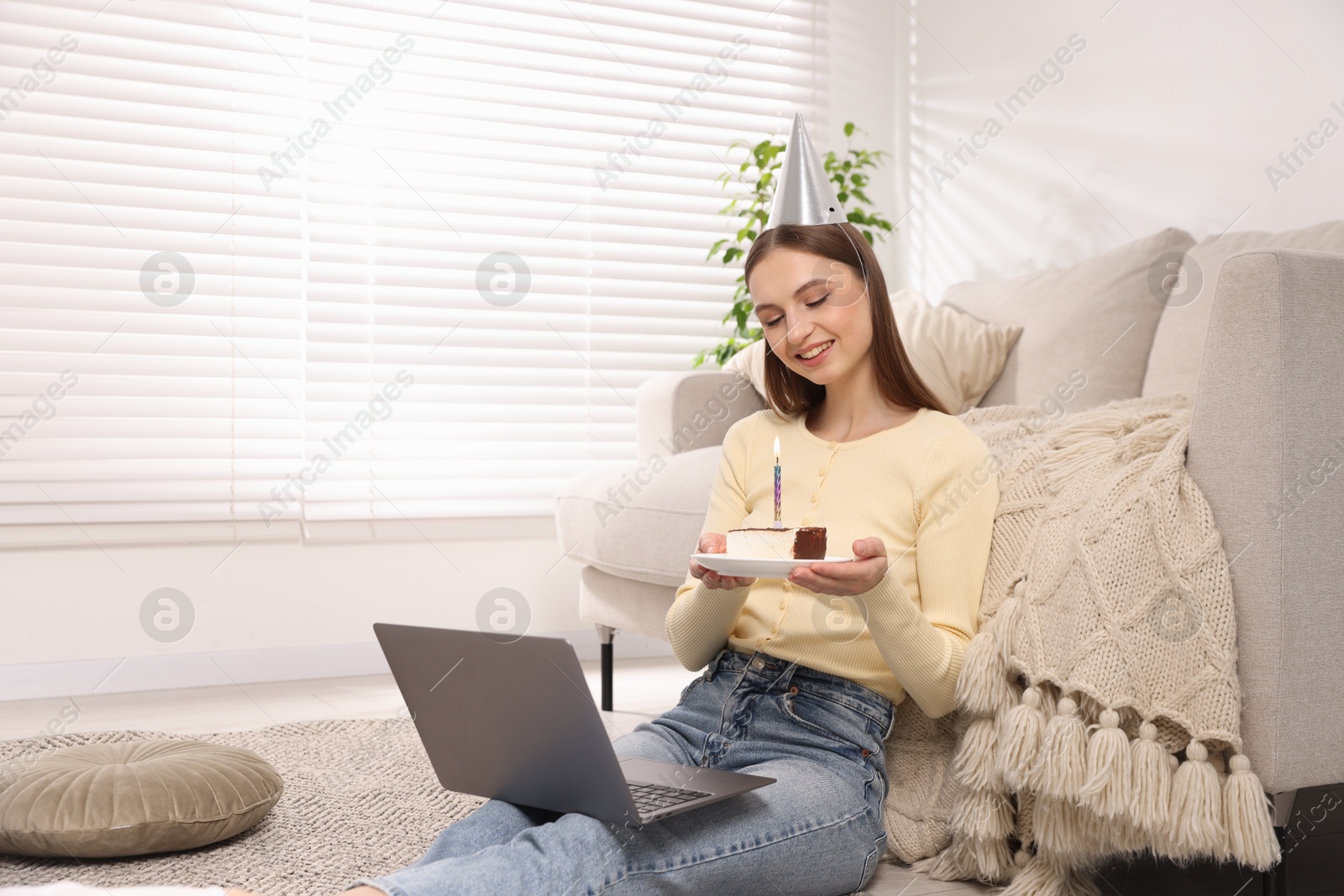 Birthday celebration. Happy woman with piece of cake having video call via laptop at home Photo of Birthday celebration. Happy woman with piece of cake having video call via laptop at home