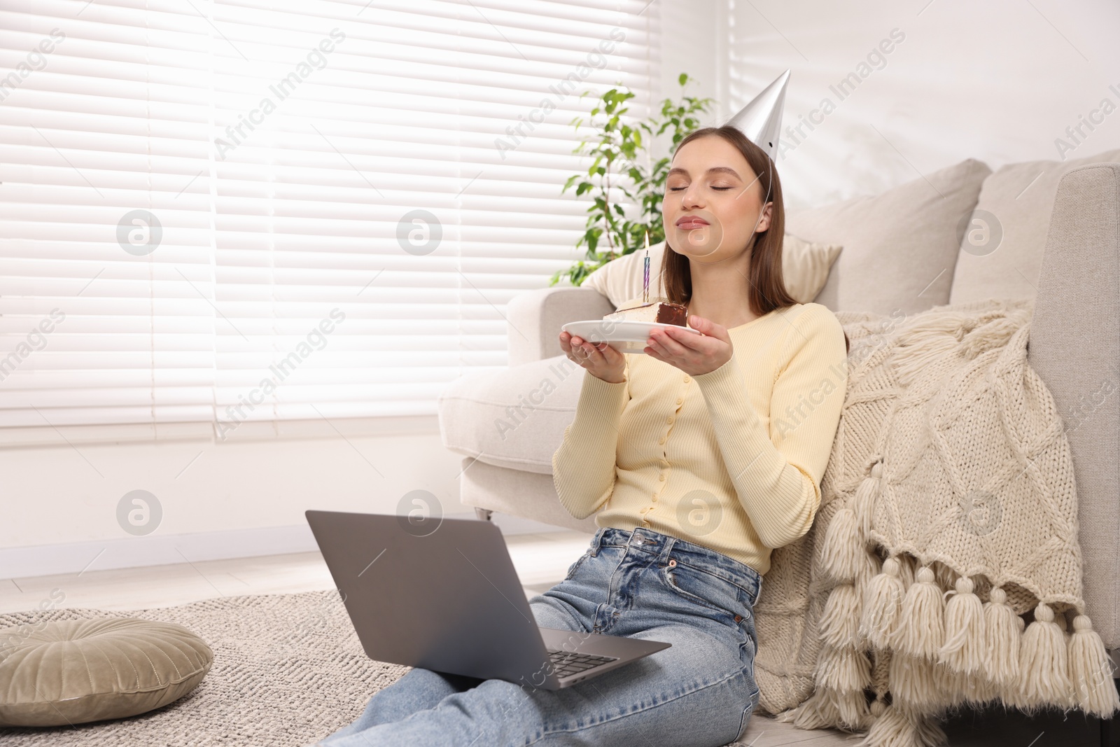 Birthday celebration. Happy woman with piece of cake having video call via laptop at home Photo of Birthday celebration. Happy woman with piece of cake having video call via laptop at home