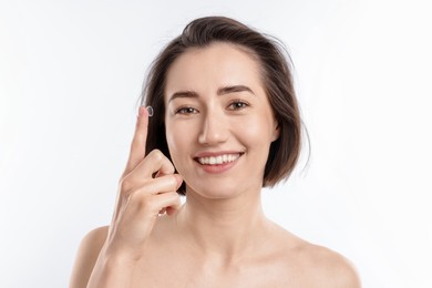 Photo of Woman with contact lens on white background