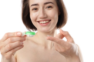 Photo of Woman with contact lens and case on white background, closeup