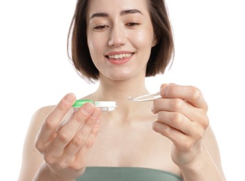Photo of Woman with contact lens and case on white background, closeup