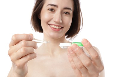 Photo of Woman with contact lens and case on white background, selective focus