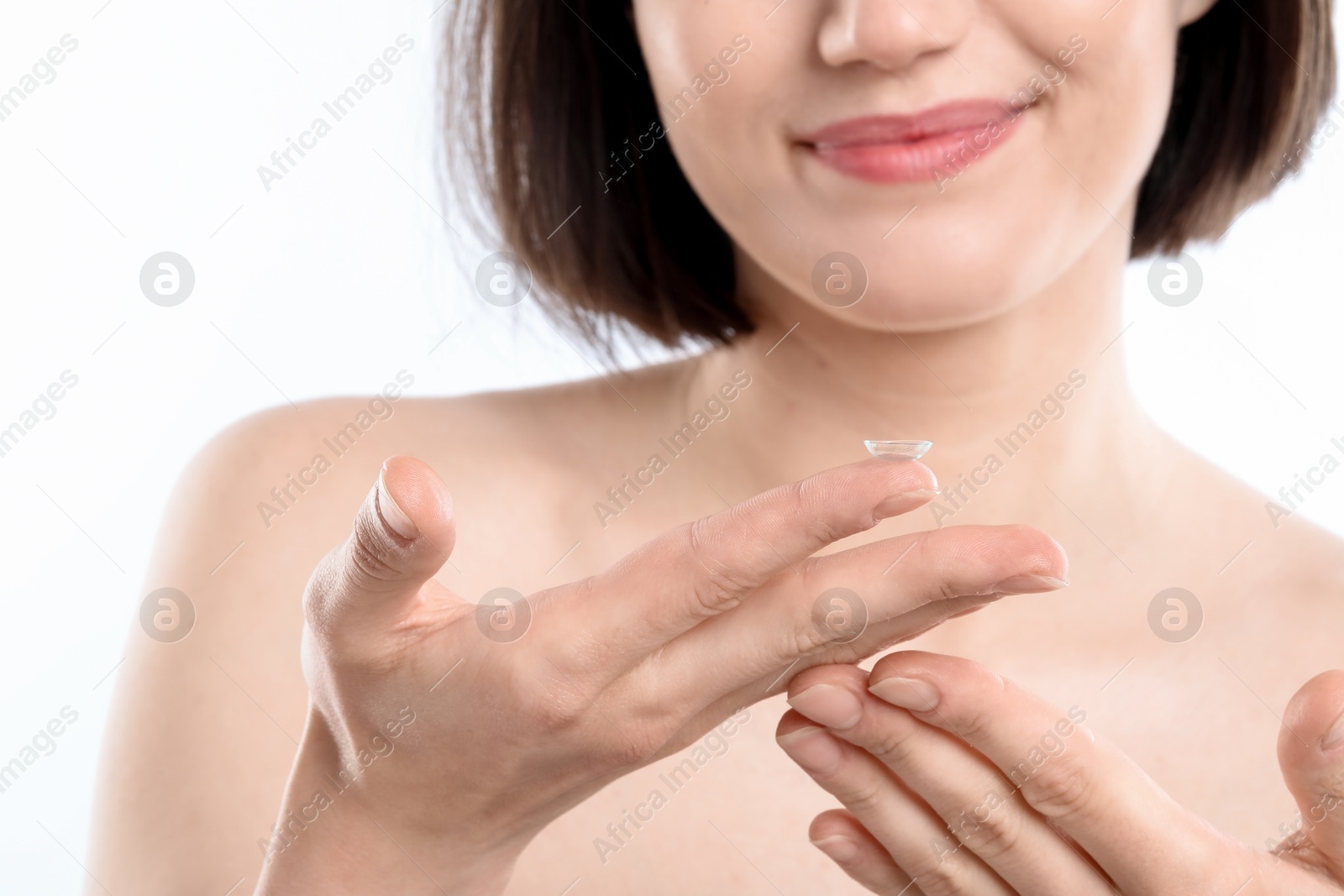 Woman with contact lens on white background, closeup Photo of Woman with contact lens on white background, closeup