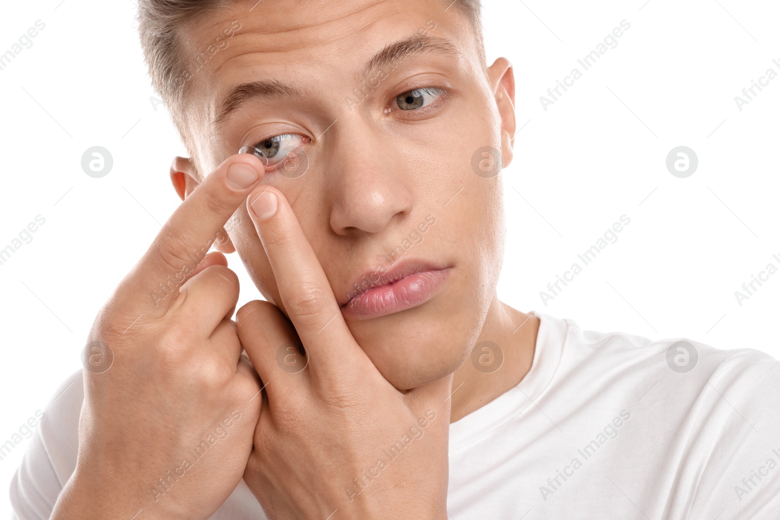 Man putting in contact lens on white background, closeup Photo of Man putting in contact lens on white background, closeup