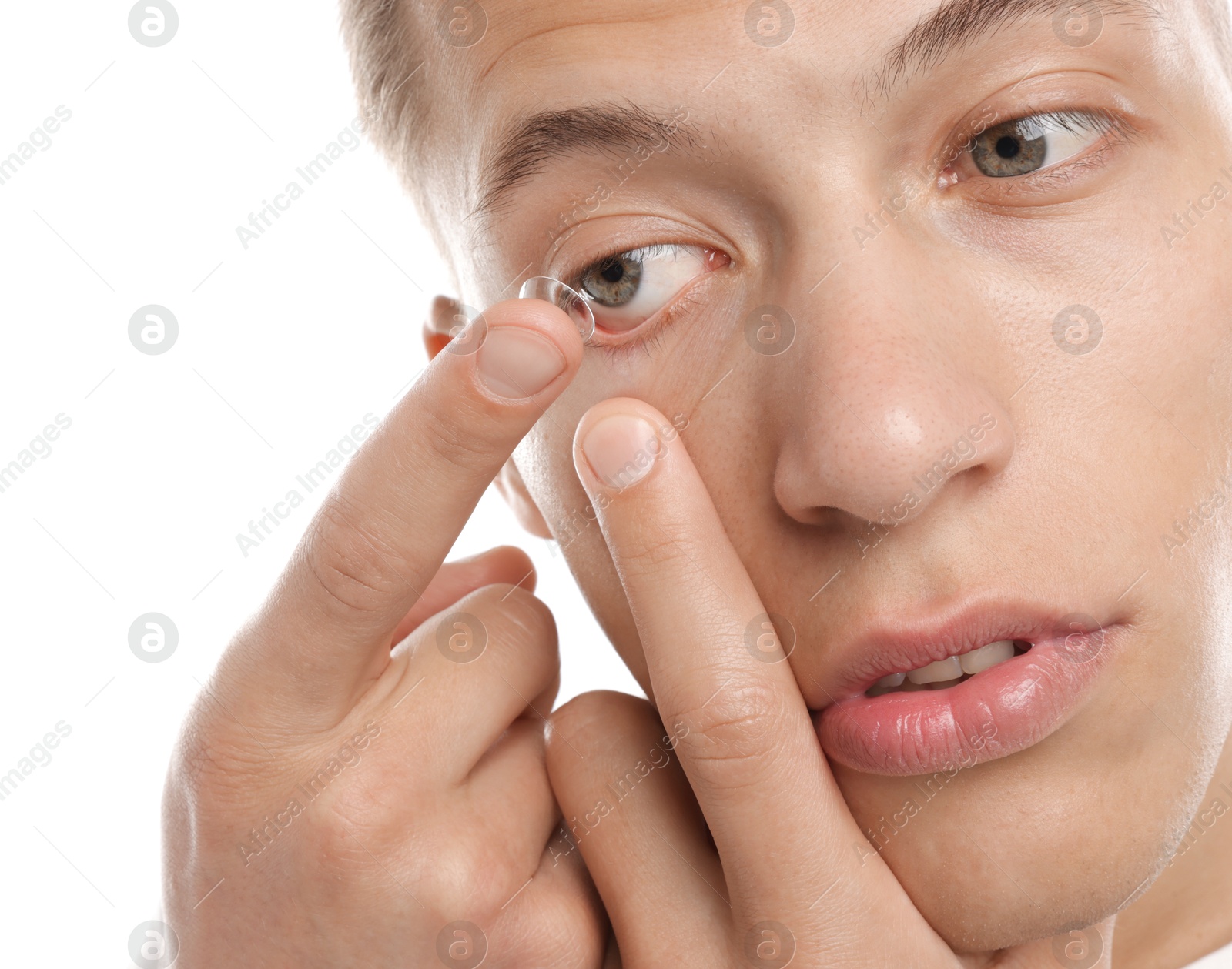 Man putting in contact lens on white background, closeup Photo of Man putting in contact lens on white background, closeup