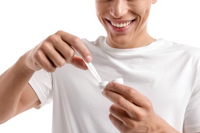 Photo of Man taking contact lens out of case on white background, closeup