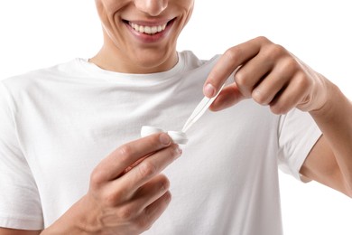 Photo of Man taking contact lens out of case on white background, closeup