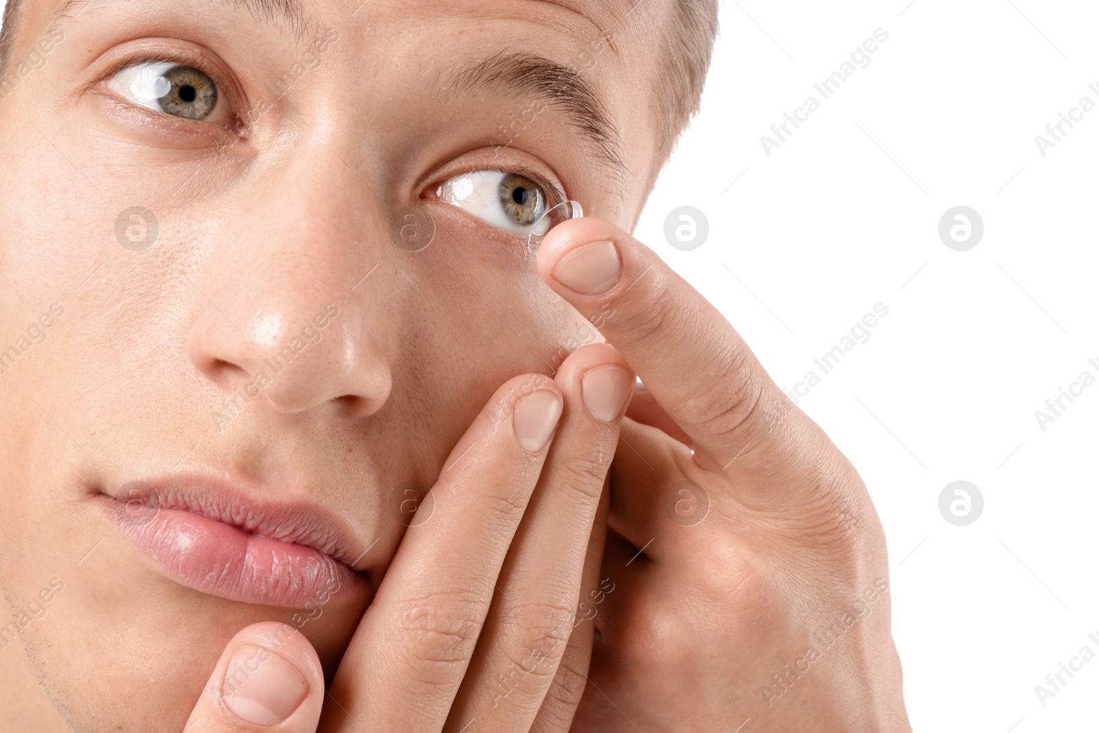 Man putting in contact lens on white background, closeup Photo of Man putting in contact lens on white background, closeup