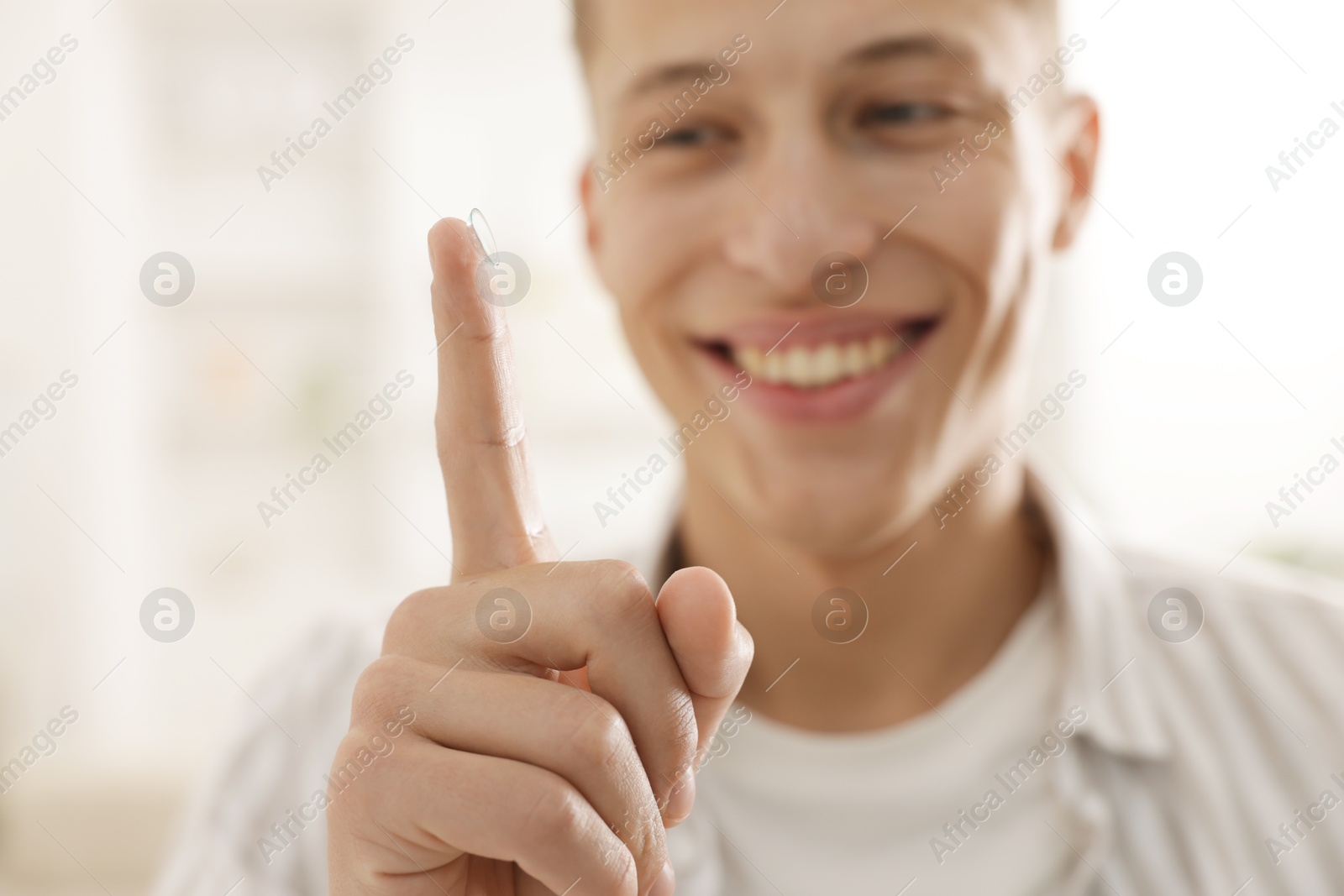 Man with contact lens at home, selective focus Photo of Man with contact lens at home, selective focus