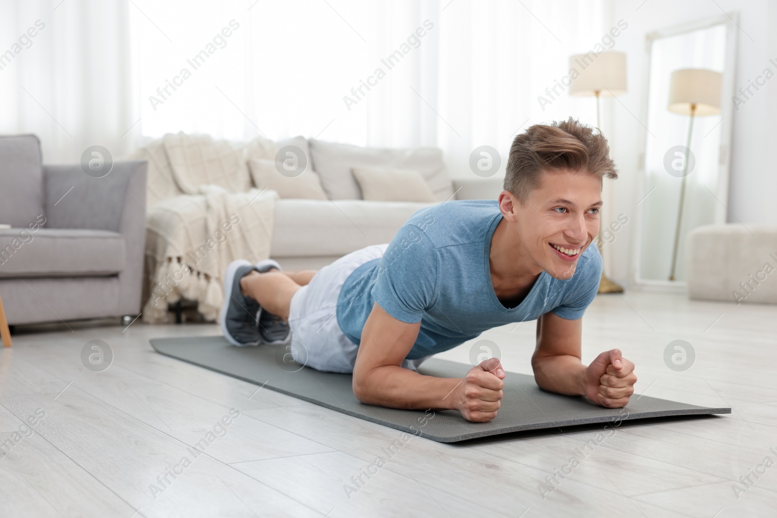 Man doing plank exercise at home. Sport and healthy lifestyle Photo of Man doing plank exercise at home. Sport and healthy lifestyle