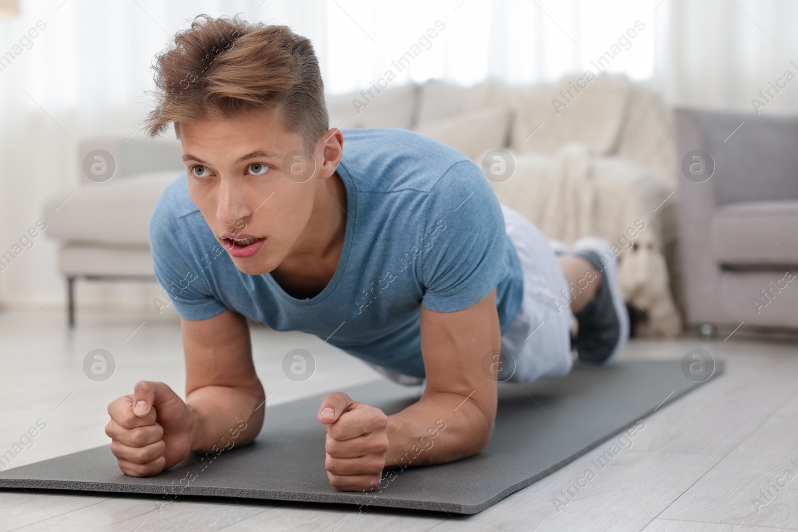Man doing plank exercise at home. Sport and healthy lifestyle Photo of Man doing plank exercise at home. Sport and healthy lifestyle