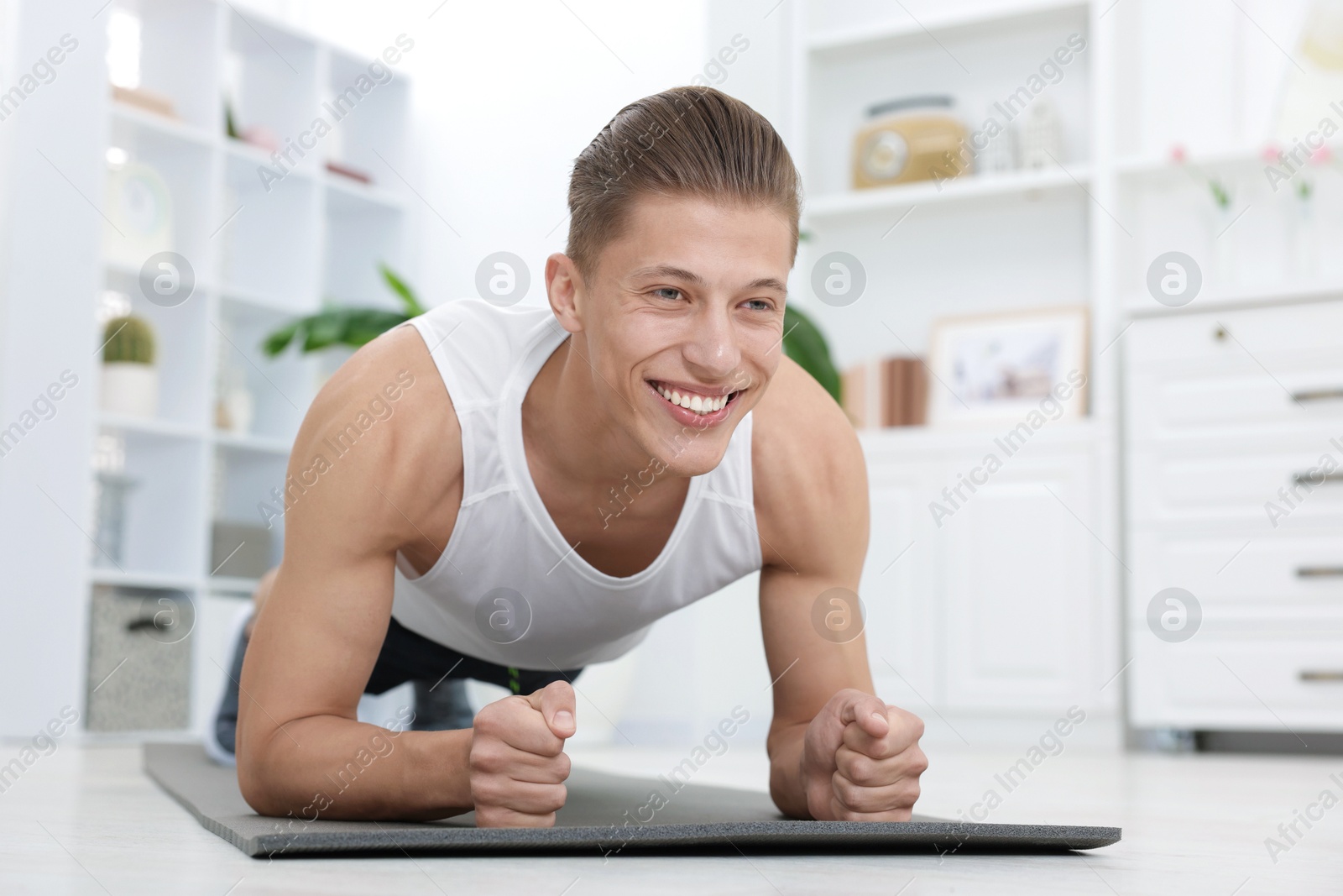 Man doing plank exercise at home. Sport and healthy lifestyle Photo of Man doing plank exercise at home. Sport and healthy lifestyle