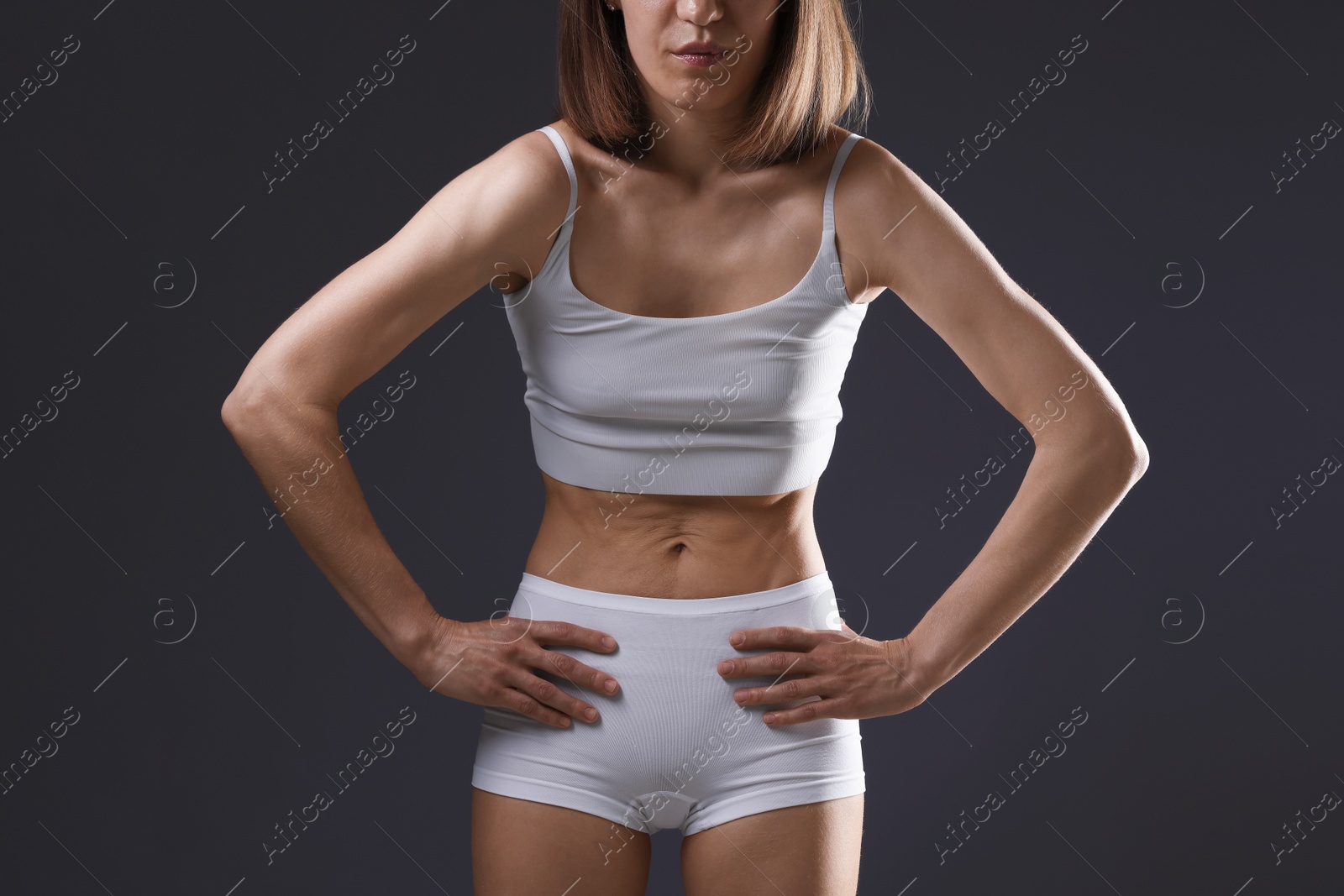 Woman suffering from anorexia on grey background, closeup Photo of Woman suffering from anorexia on grey background, closeup