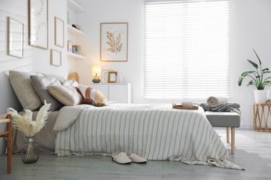 Photo of Comfortable bed with soft linens in room. Home textile