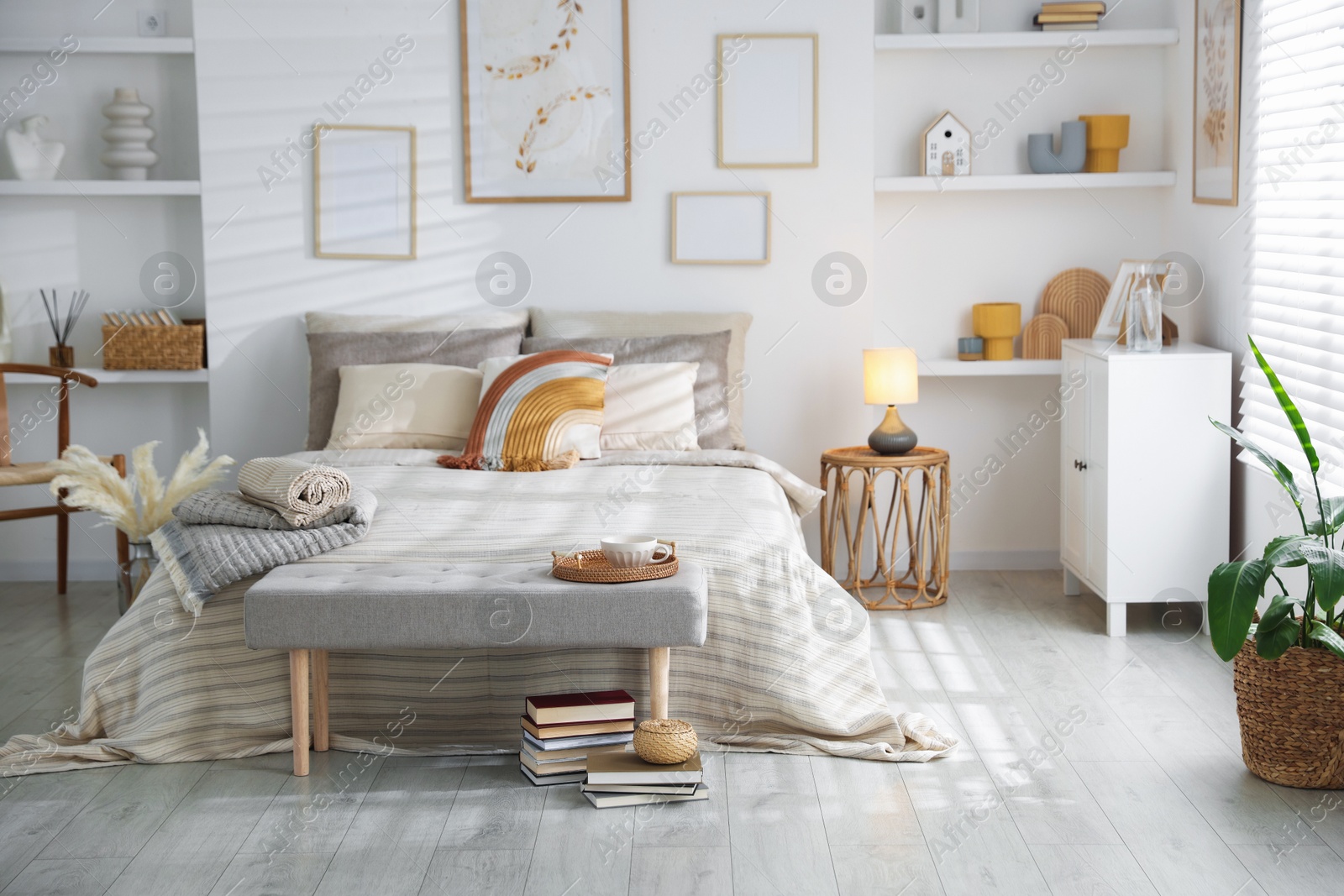 Comfortable bed with soft linens in room. Home textile Photo of Comfortable bed with soft linens in room. Home textile