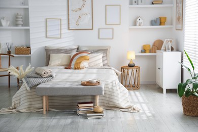 Photo of Comfortable bed with soft linens in room. Home textile