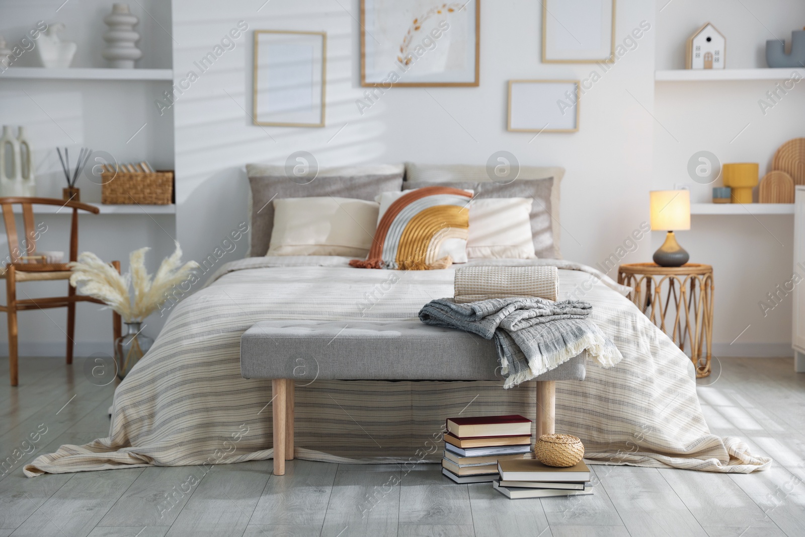 Comfortable bed with soft linens in room. Home textile Photo of Comfortable bed with soft linens in room. Home textile
