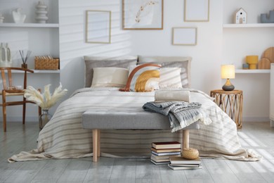 Photo of Comfortable bed with soft linens in room. Home textile