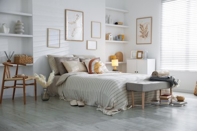 Photo of Comfortable bed with soft linens in room. Home textile