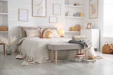Photo of Comfortable bed with soft linens in room. Home textile