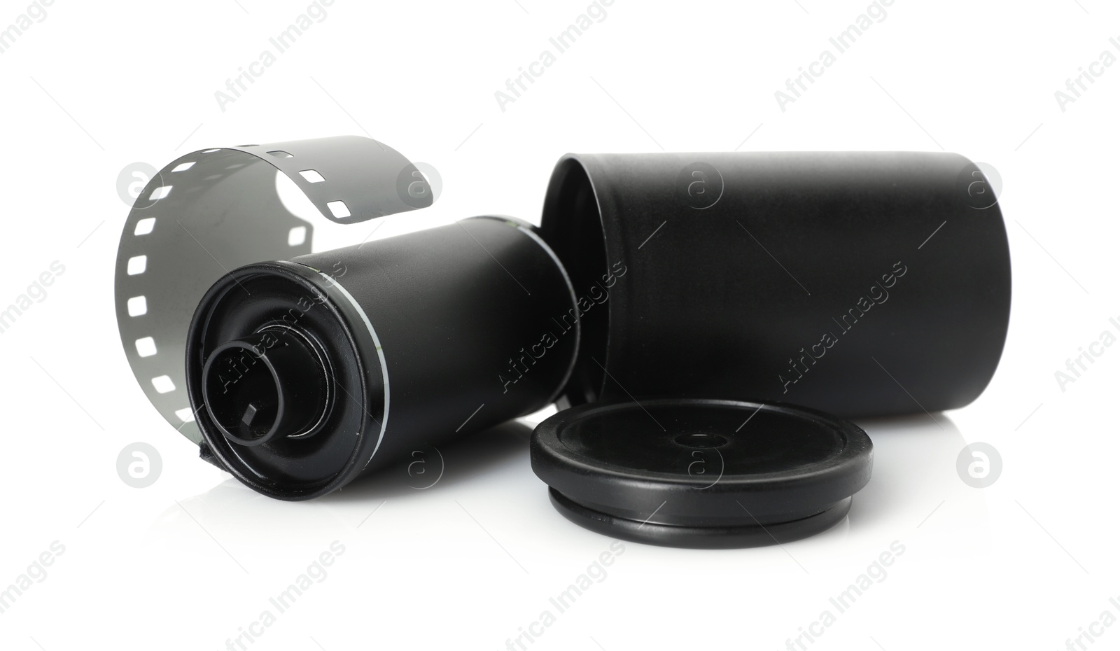Roll of photographic film and canister isolated on white Photo of Roll of photographic film and canister isolated on white