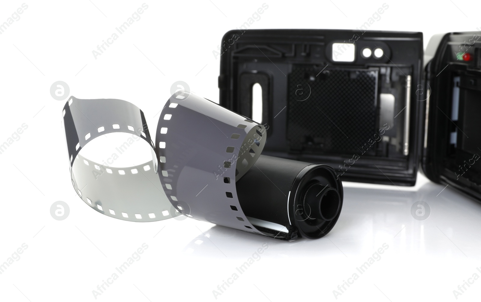 Roll of photographic film and photo camera isolated on white Photo of Roll of photographic film and photo camera isolated on white