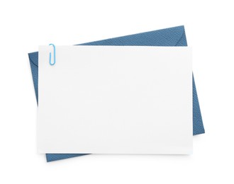 Photo of Blank invitation card and envelope isolated on white, top view. Space for design