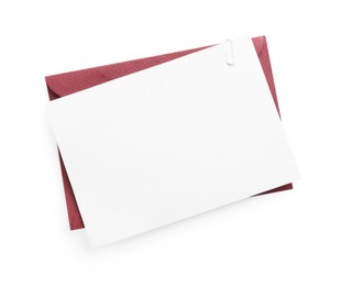 Photo of Blank invitation card and envelope isolated on white, top view. Space for design