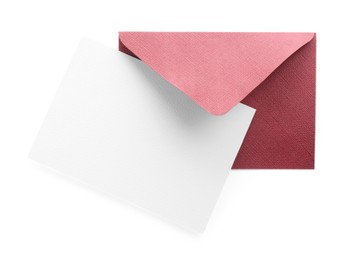 Photo of Blank invitation card and envelope isolated on white, top view. Space for design