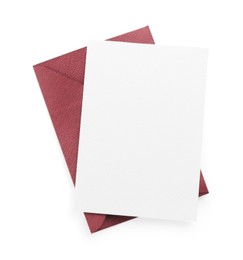 Photo of Blank invitation card and envelope isolated on white, top view. Space for design